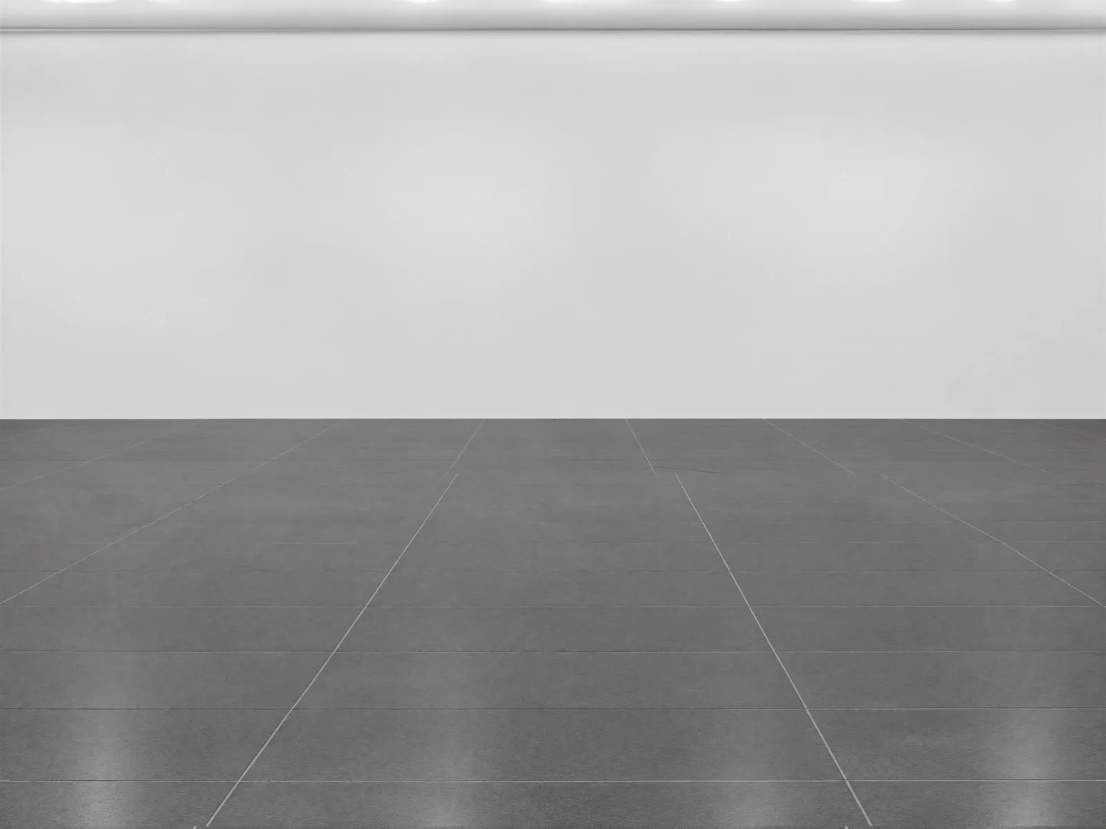 The “White wall, dark tile floor” background on its own, with no vehicle.