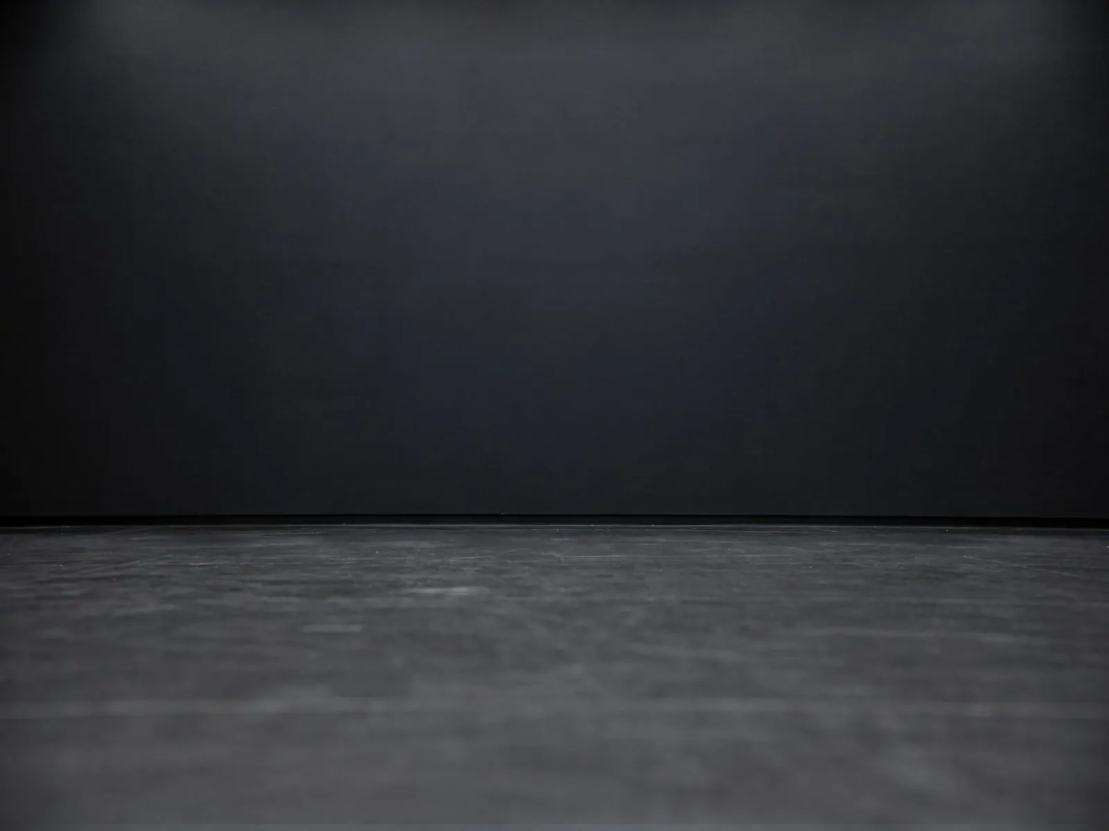 The “Dark showroom (deep floor)” background on its own, with no vehicle.