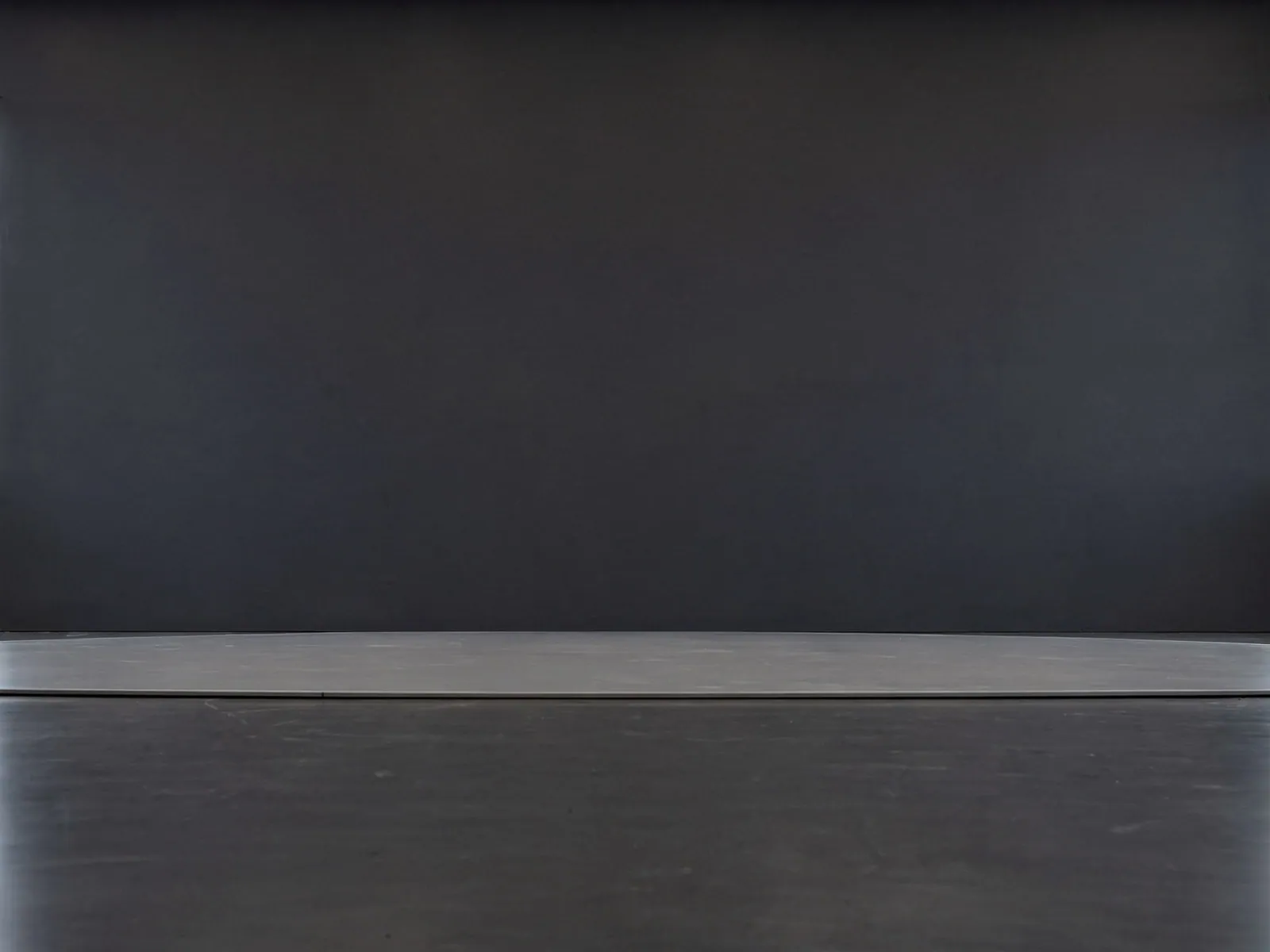 The “Dark showroom (soft wall)” background on its own, with no vehicle.